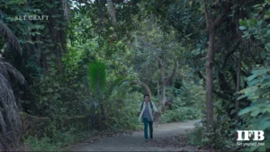 man walking forest path indian film establishing shot natural environment