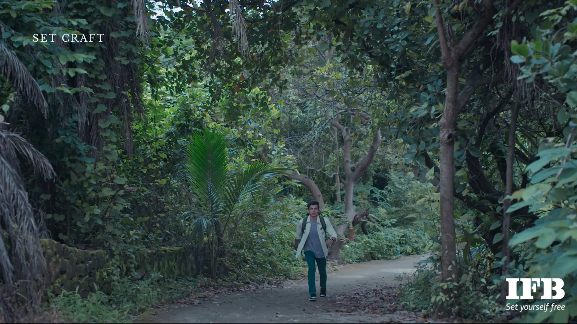 man walking forest path indian film establishing shot natural environment