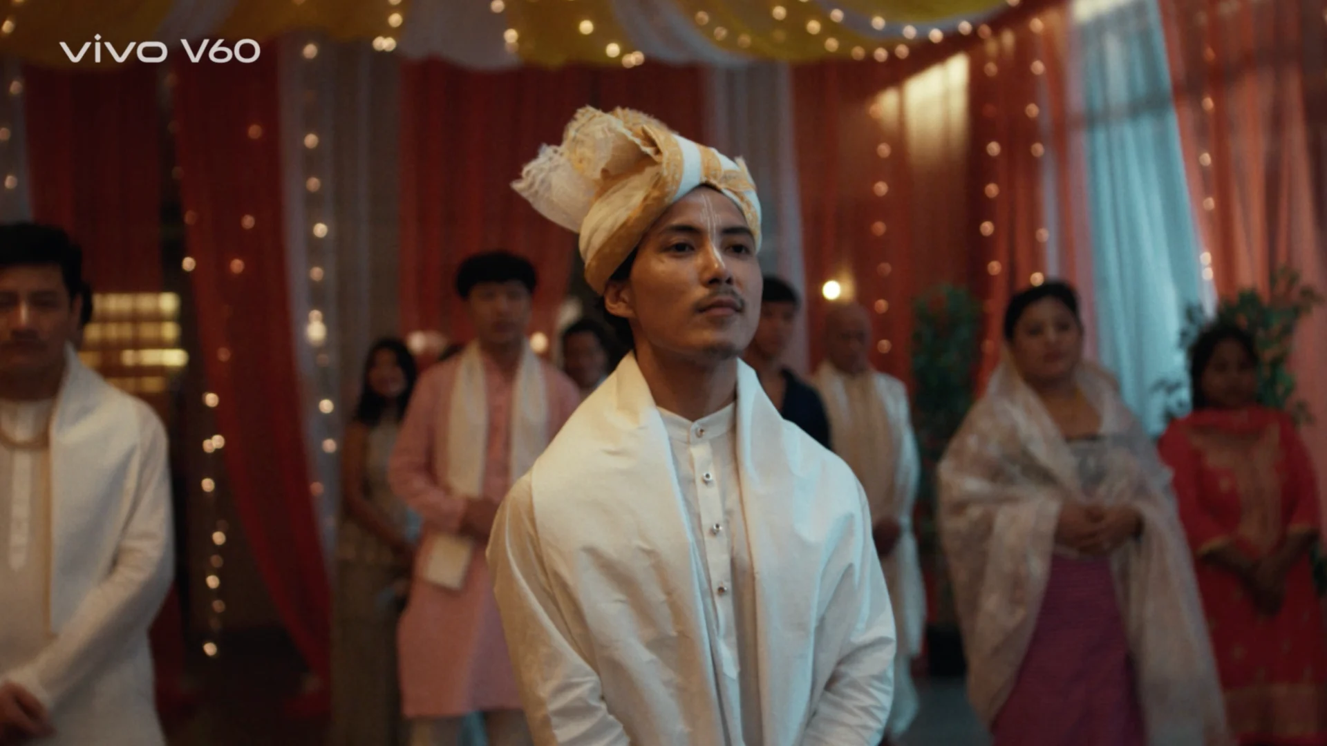 manipuri groom traditional attire wedding hall drapes warm lights