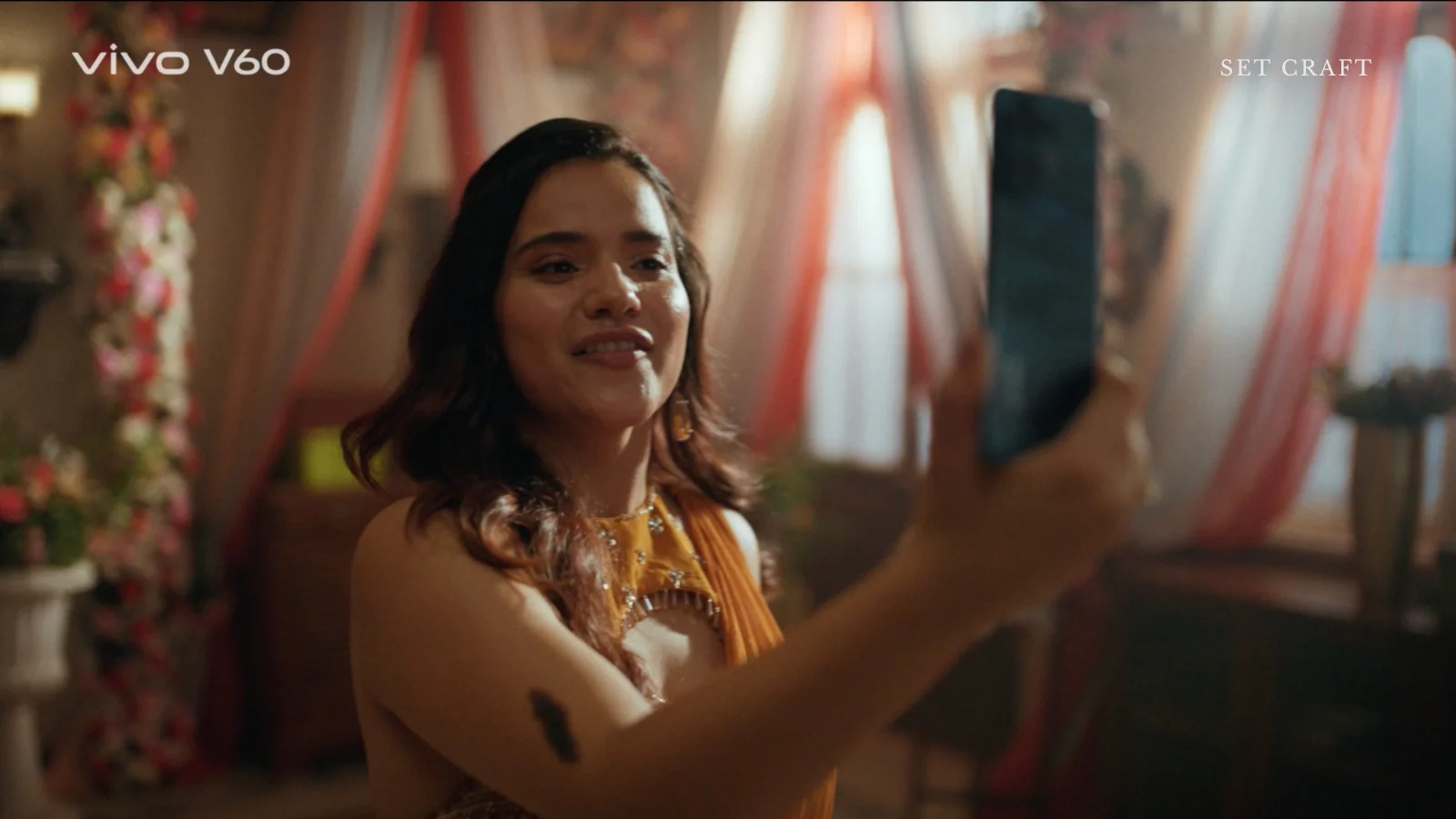 woman taking selfie wedding indoor drapes warm lighting set design