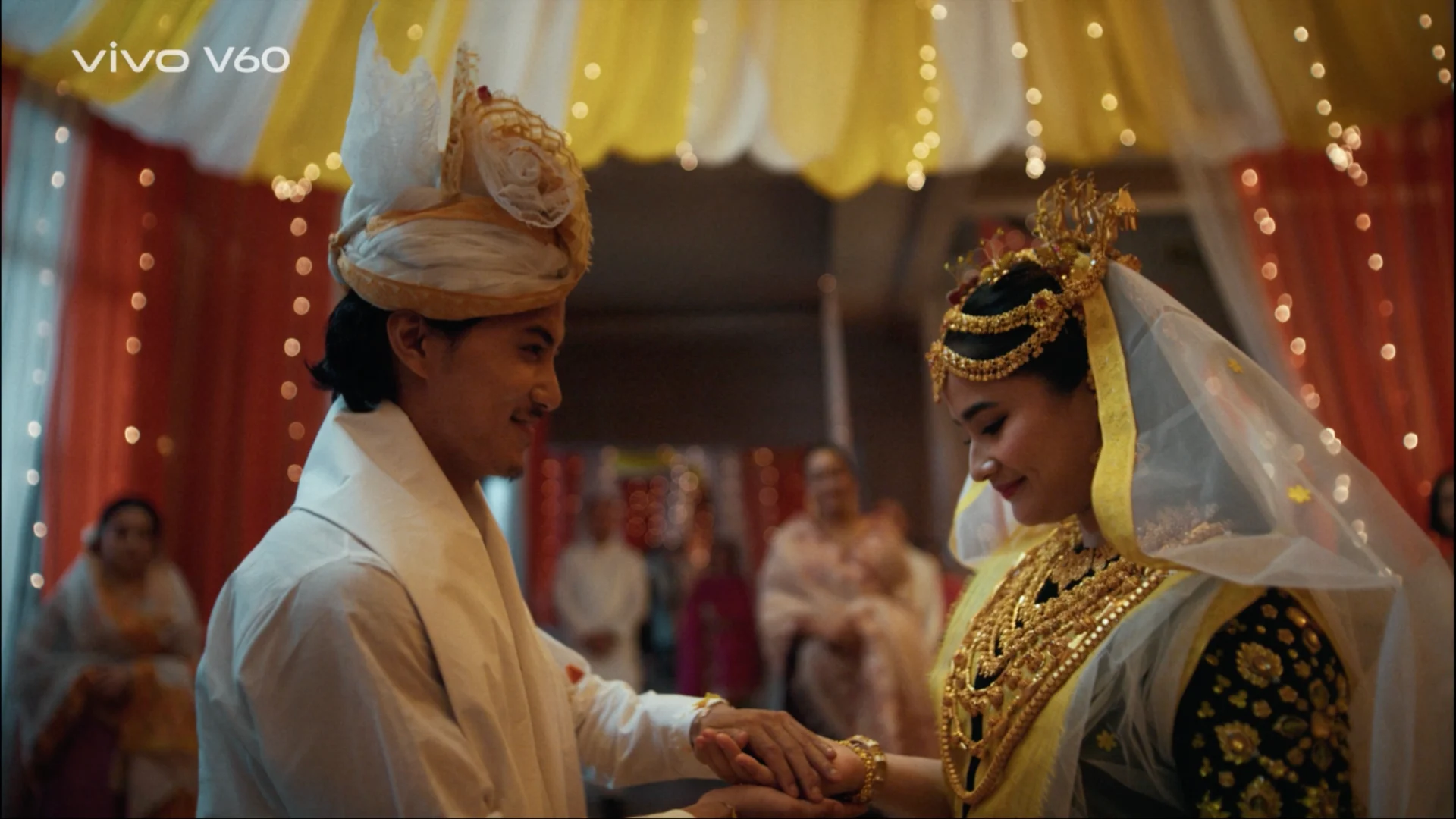 manipuri bride groom holding hands wedding ceremony warm lighting