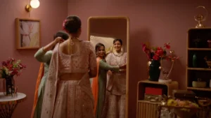 Bridal dressing room set with warm pink interiors, floral decor, and wedding styling for a cinematic advertisement shoot.