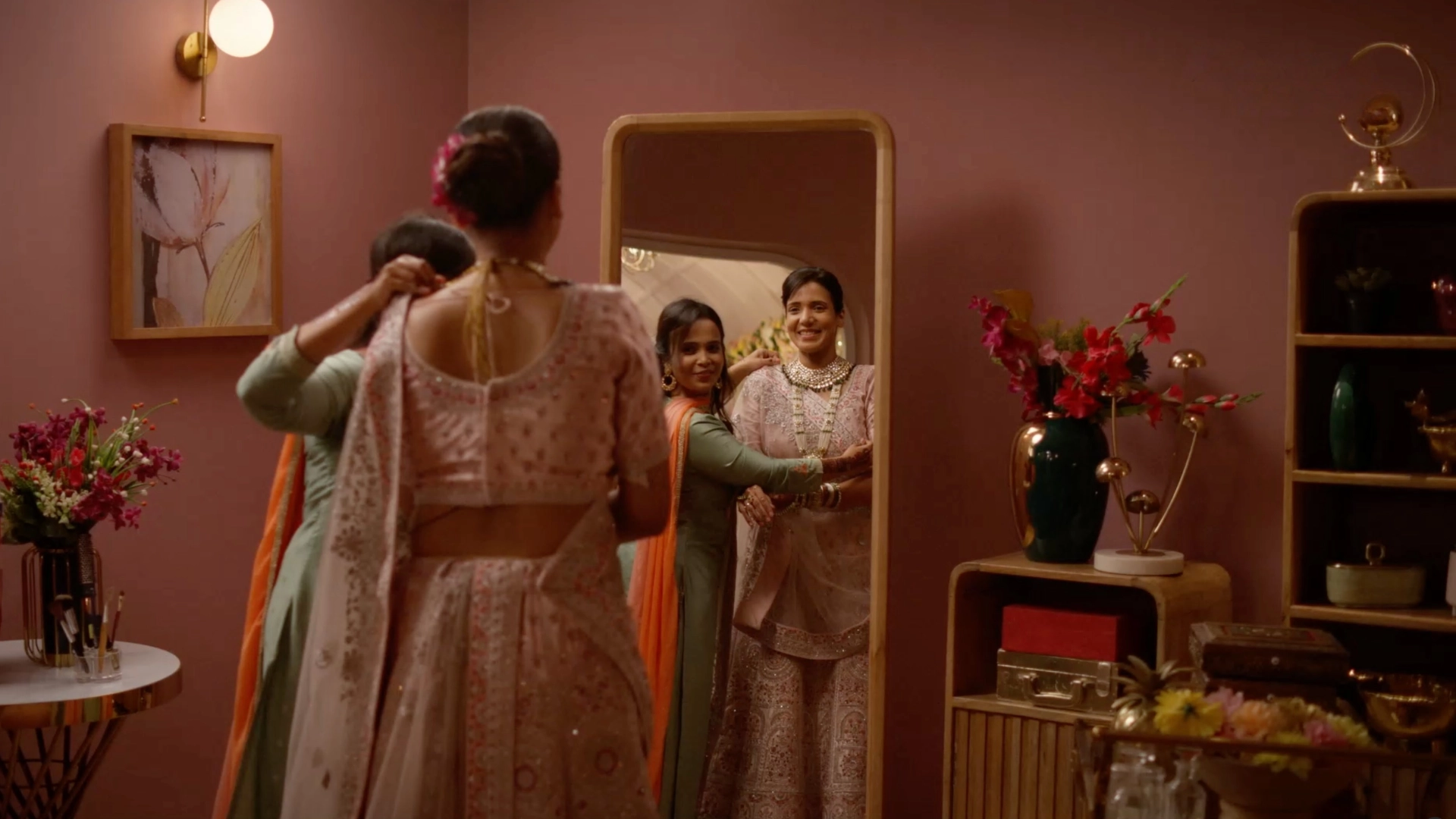 Bridal dressing room set with warm pink interiors, floral decor, and wedding styling for a cinematic advertisement shoot.