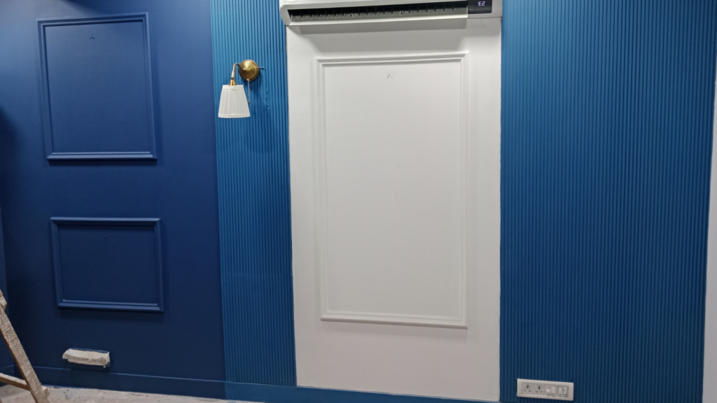 Completed blue wall panel finishing and paint treatment inside the studio