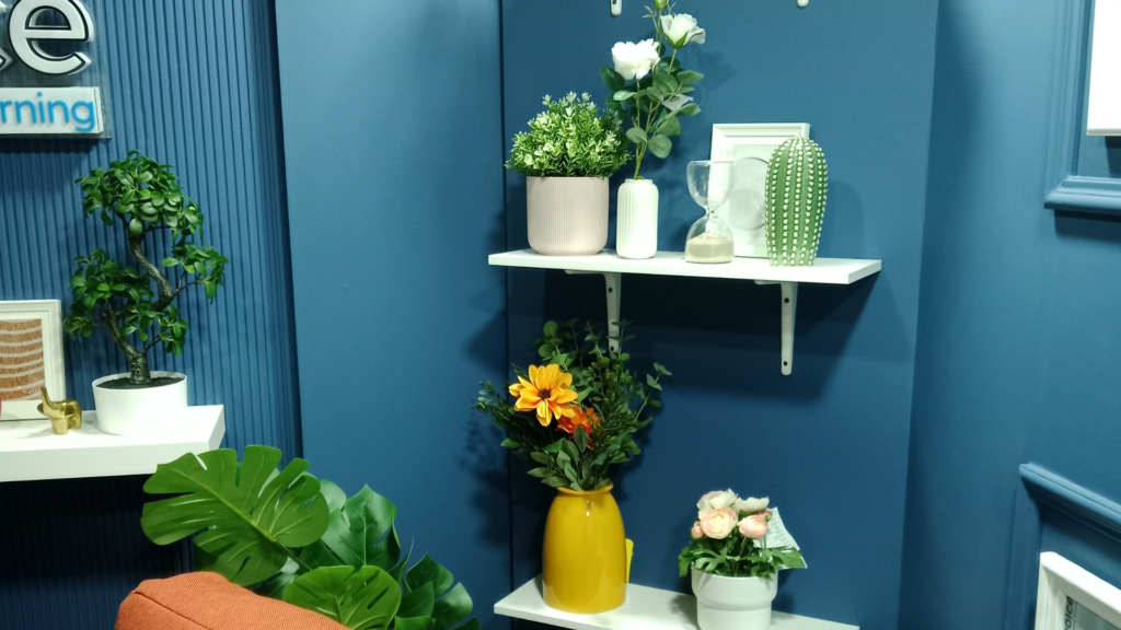 Completed studio corner styling with finished blue walls and decorative shelving