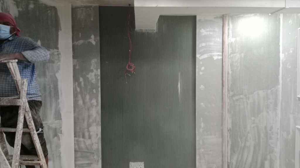 Fluted wall panel installation during surface treatment and studio finishing process