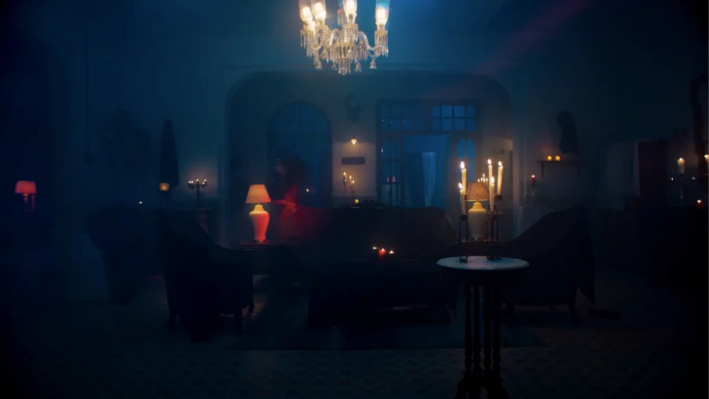Haunted house interior set with candles, chandeliers and blue cinematic lighting created for a horror sequence.