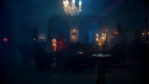 Haunted house interior set with candles, chandeliers and blue cinematic lighting created for a horror sequence.