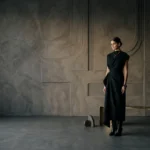 Cinematic noir interior composition featuring sculptural wall detailing, muted textures, atmospheric lighting, and minimalist spatial styling by Set Craft Atelier.