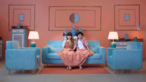 Pastel blue and coral living room set with symmetrical styling and cinematic advertisement interiors.