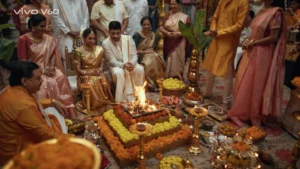 Traditional South Indian wedding ceremony set with floral decor, brass elements and warm festive lighting.