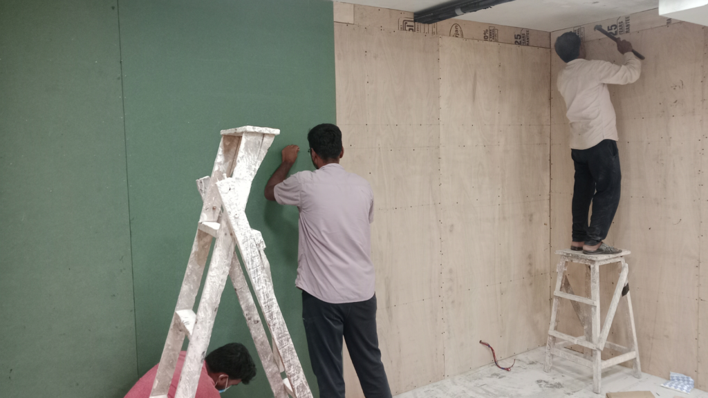Wall finishing and acoustic surface treatment process during studio construction