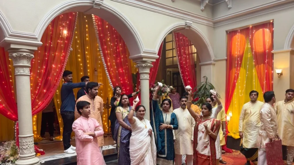 Actors and crew rehearsing a Bengali wedding celebration scene inside the production-designed set.