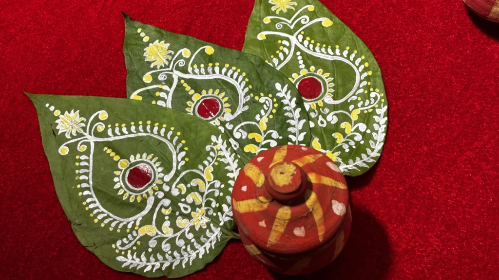 Hand-painted betel leaves prepared for Bengali wedding rituals and ceremonial sequences.