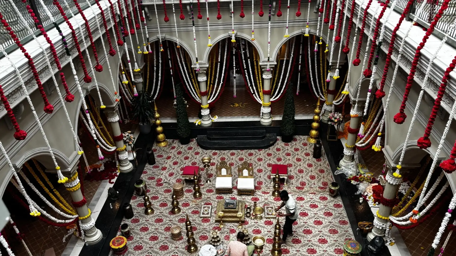 Top view of a traditional wedding set with floral decorations and ceremonial seating designed for a Vivo advertising film.