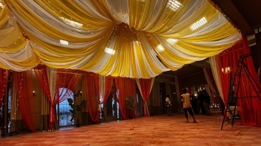 Completed wedding set featuring fabric installations and ambient lighting before filming.