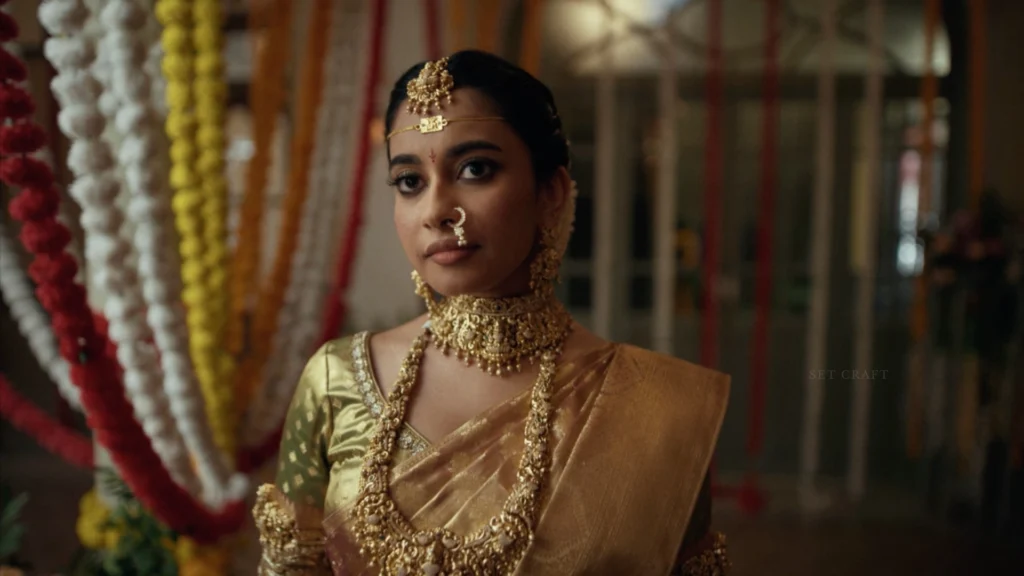 Portrait of a bride wearing traditional jewellery and silk saree inside a floral wedding venue designed by Set Craft.