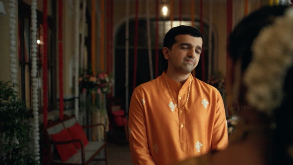 Male character dressed in traditional South Indian attire inside a wedding venue designed by Set Craft.