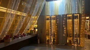 Decorative wedding bedroom styling with drapery lighting and floral installations